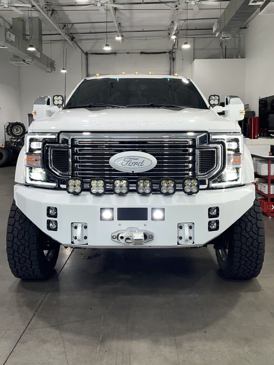White Ford truck in a garage with visible branding