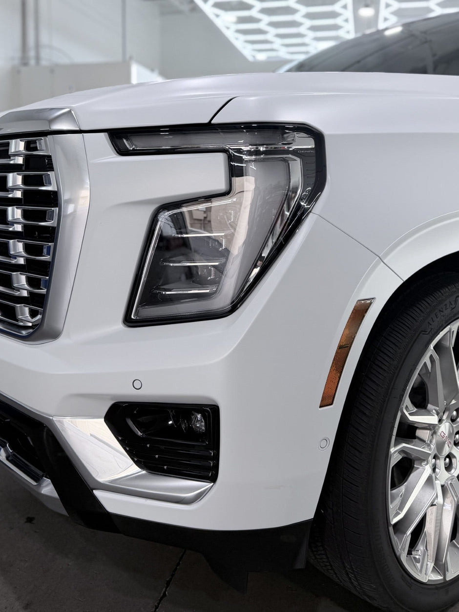 White gmc SUV in a showroom setting