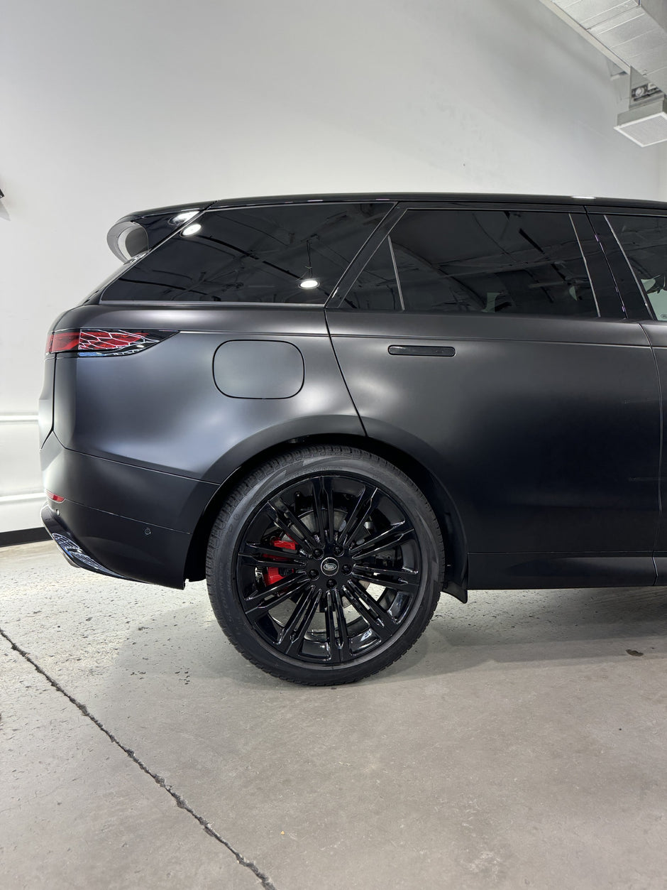 Matte black SUV parked inside a building