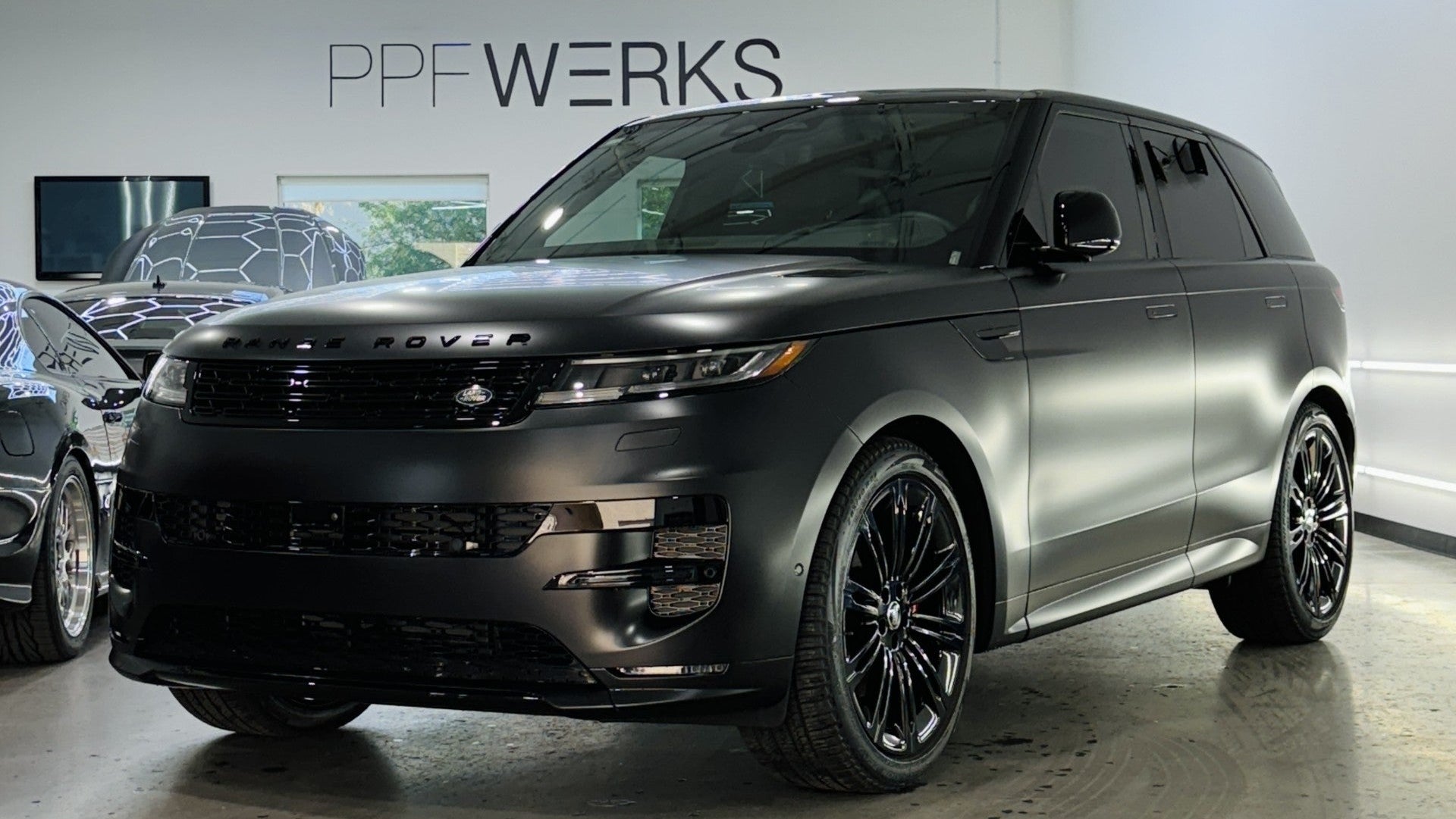 Black Range Rover in a showroom with 'PPF Werks' branding.