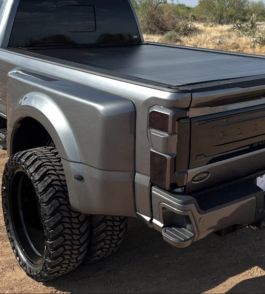 Silver truck with a tonneau cover in a desert setting