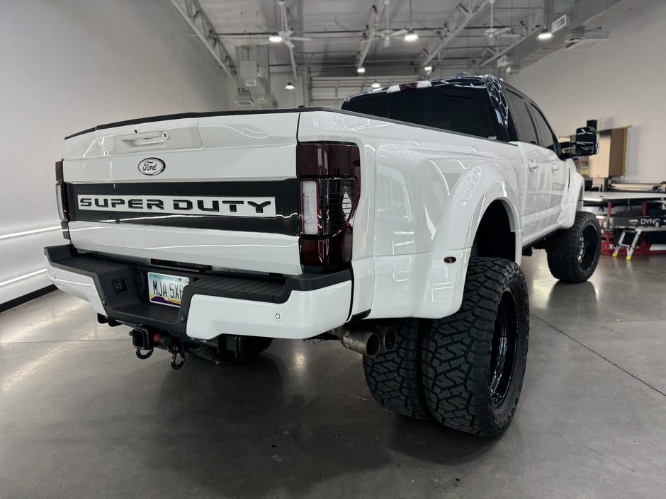 White Ford Super Duty truck in a warehouse setting